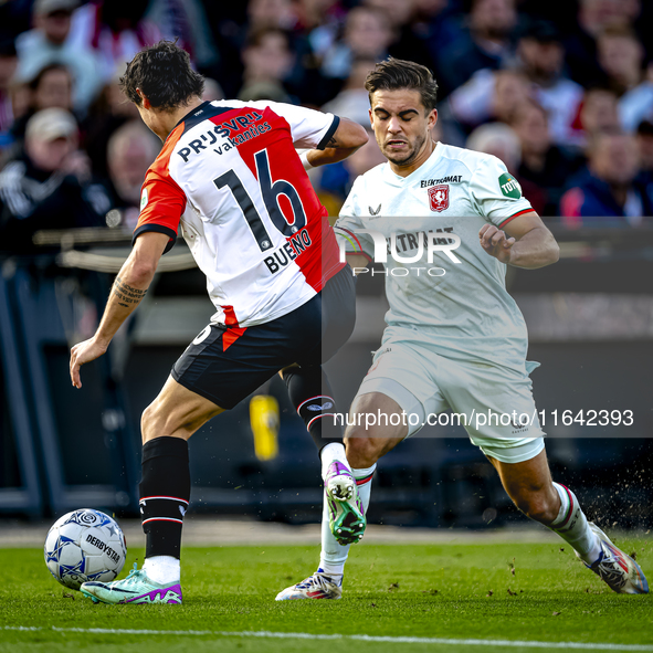 FC Twente defender Bart van Rooij and Feyenoord Rotterdam defender Hugo Bueno play during the match between Feyenoord and Twente at the Feye...