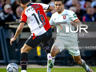 FC Twente defender Bart van Rooij and Feyenoord Rotterdam defender Hugo Bueno play during the match between Feyenoord and Twente at the Feye...