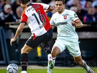 FC Twente defender Bart van Rooij and Feyenoord Rotterdam defender Hugo Bueno play during the match between Feyenoord and Twente at the Feye...