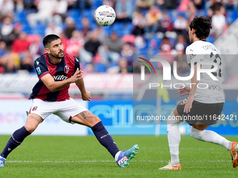 Martin Erlic of Bologna FC and Matteo Cancellieri of Parma Calcio 1903 compete for the ball during the Serie A Enilive match between Bologna...