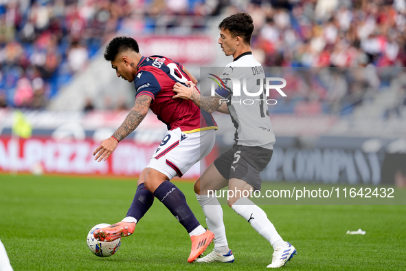 Santiago Castro of Bologna FC and Enrico Delprato of Parma Calcio 1903 compete for the ball during the Serie A Enilive match between Bologna...