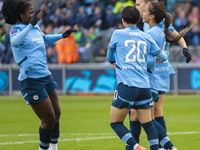 Mary Fowler #8 of Manchester City W.F.C. celebrates her goal with teammates during the Barclays FA Women's Super League match between Manche...