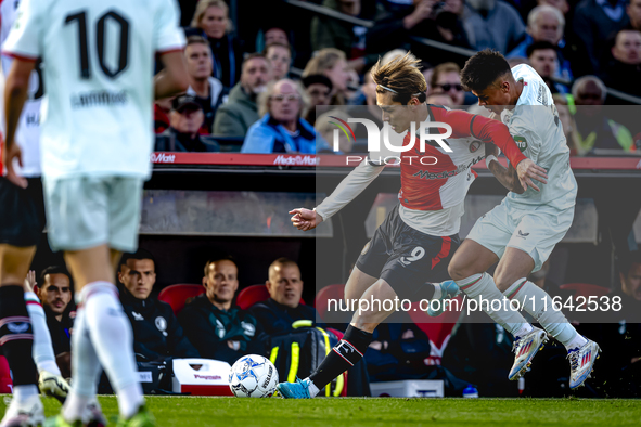 Feyenoord Rotterdam forward Ayase Ueda and FC Twente defender Mees Hilgers play during the match between Feyenoord and Twente at the Feyenoo...