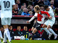 Feyenoord Rotterdam forward Ayase Ueda and FC Twente defender Mees Hilgers play during the match between Feyenoord and Twente at the Feyenoo...