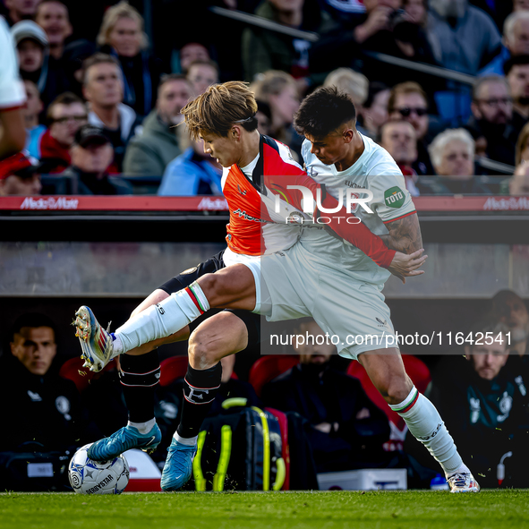 Feyenoord Rotterdam forward Ayase Ueda and FC Twente defender Mees Hilgers play during the match between Feyenoord and Twente at the Feyenoo...