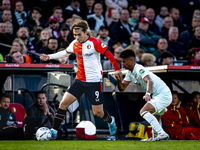 Feyenoord Rotterdam forward Ayase Ueda and FC Twente defender Mees Hilgers play during the match between Feyenoord and Twente at the Feyenoo...