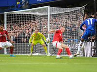 Noni Madueke of Chelsea shoots at goal as Matz Sels, Nottingham Forest goalkeeper, makes a save during the Premier League match between Chel...