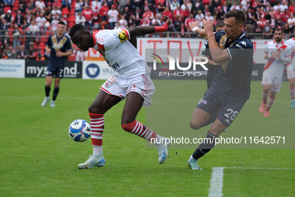 Davis Mensah of Mantova 1911 is followed by Davide Adorni of Brescia Calcio FC during the Italian Serie B soccer championship match between...