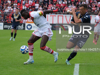 Davis Mensah of Mantova 1911 is followed by Davide Adorni of Brescia Calcio FC during the Italian Serie B soccer championship match between...