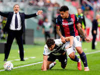 Santiago Castro of Bologna FC and Botond Balogh of Parma Calcio 1903 compete for the ball during the Serie A Enilive match between Bologna F...