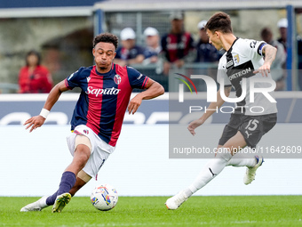 Dan Ndoye of Bologna FC and Enrico Delprato of Parma Calcio 1903 compete for the ball during the Serie A Enilive match between Bologna FC an...