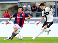 Dan Ndoye of Bologna FC and Enrico Delprato of Parma Calcio 1903 compete for the ball during the Serie A Enilive match between Bologna FC an...