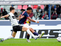 Dan Ndoye of Bologna FC and Enrico Delprato of Parma Calcio 1903 compete for the ball during the Serie A Enilive match between Bologna FC an...