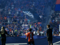 A boy records on his cell phone while holding the MLS banner before the start of the Major League Soccer match between FC Cincinnati and Orl...