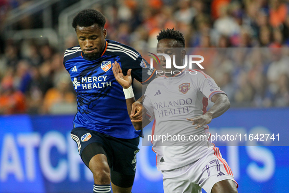 Orlando midfielder Ivan Angulo and Cincinnati defender Alvas Powell compete for the ball during the Major League Soccer match between FC Cin...