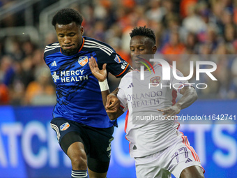 Orlando midfielder Ivan Angulo and Cincinnati defender Alvas Powell compete for the ball during the Major League Soccer match between FC Cin...