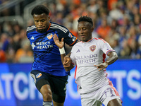 Orlando midfielder Ivan Angulo and Cincinnati defender Alvas Powell compete for the ball during the Major League Soccer match between FC Cin...