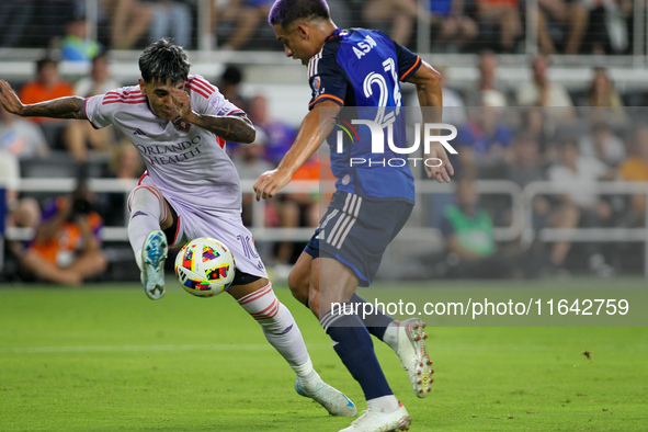 Orlando midfielder Facundo Torres and Cincinnati midfielder Yamil Asad compete for the ball during the Major League Soccer match between FC...