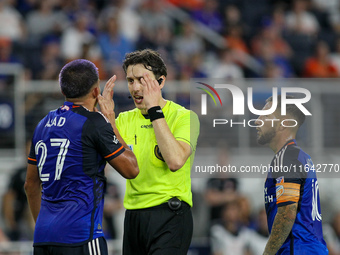 Referee Filip Dujic explains a call to Cincinnati midfielder Yamil Asad during the Major League Soccer match between FC Cincinnati and Orlan...