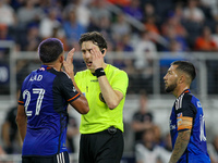 Referee Filip Dujic explains a call to Cincinnati midfielder Yamil Asad during the Major League Soccer match between FC Cincinnati and Orlan...