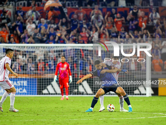 Cincinnati attacker Kevin Kelsy and Orlando defender Rodrigo Schlegel compete for the ball during the Major League Soccer match between FC C...