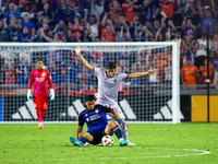 Cincinnati attacker Kevin Kelsy and Orlando defender Rodrigo Schlegel compete for the ball during the Major League Soccer match between FC C...