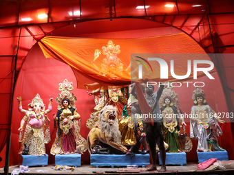 A worker works in a ''pandal'' or temporary platform in front of idols of the Hindu goddess Durga ahead of the Durga Puja festival in Kolkat...