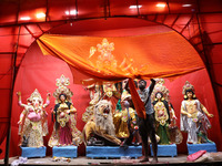 A worker works in a ''pandal'' or temporary platform in front of idols of the Hindu goddess Durga ahead of the Durga Puja festival in Kolkat...