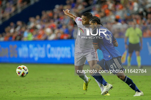 Cincinnati defender DeAndre Yedlin and Orlando attacker Luis Muriel compete for the ball during the Major League Soccer match between FC Cin...