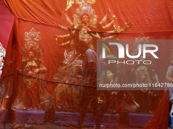 A worker works in a ''pandal'' or temporary platform in front of idols of the Hindu goddess Durga ahead of the Durga Puja festival in Kolkat...