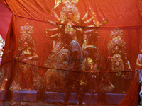 A worker works in a ''pandal'' or temporary platform in front of idols of the Hindu goddess Durga ahead of the Durga Puja festival in Kolkat...