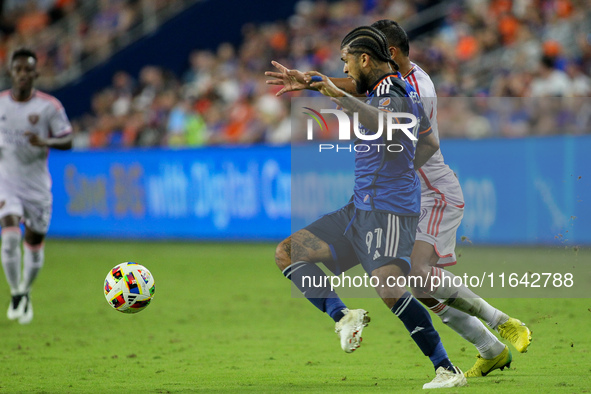 Cincinnati defender DeAndre Yedlin and Orlando attacker Luis Muriel compete for the ball during the Major League Soccer match between FC Cin...