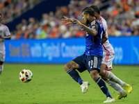 Cincinnati defender DeAndre Yedlin and Orlando attacker Luis Muriel compete for the ball during the Major League Soccer match between FC Cin...