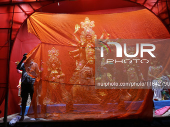 A worker works in a ''pandal'' or temporary platform in front of idols of the Hindu goddess Durga ahead of the Durga Puja festival in Kolkat...