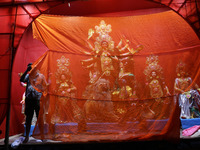 A worker works in a ''pandal'' or temporary platform in front of idols of the Hindu goddess Durga ahead of the Durga Puja festival in Kolkat...