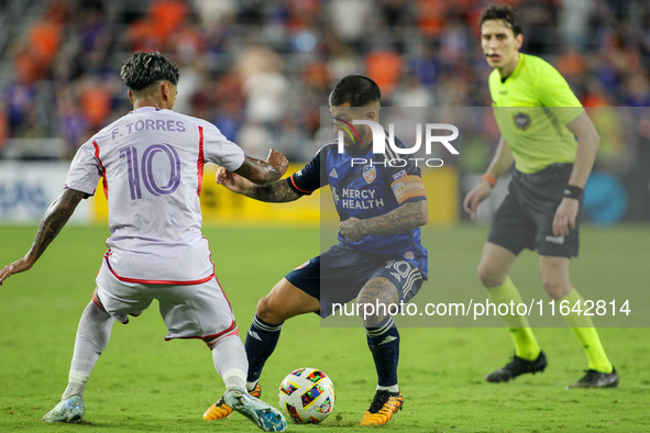 Cincinnati midfielder Luciano Acosta and Orlando midfielder Facundo Torres compete for the ball during the Major League Soccer match between...