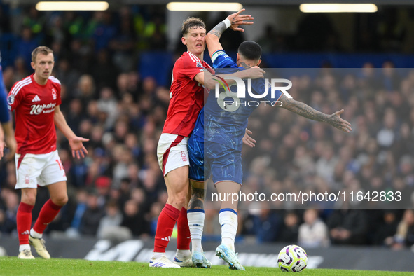 Enzo Fernandez of Chelsea catches Ryan Yates of Nottingham Forest in the face with his elbow during the Premier League match between Chelsea...