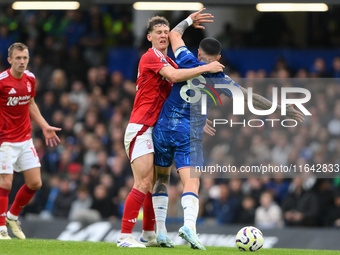 Enzo Fernandez of Chelsea catches Ryan Yates of Nottingham Forest in the face with his elbow during the Premier League match between Chelsea...