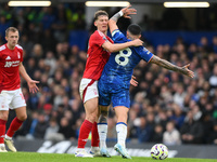 Enzo Fernandez of Chelsea catches Ryan Yates of Nottingham Forest in the face with his elbow during the Premier League match between Chelsea...