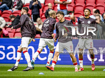 AFC Ajax Amsterdam forward Mika Godts and AFC Ajax Amsterdam defender Devyne Rensch participate in the match between Ajax and Groningen at t...