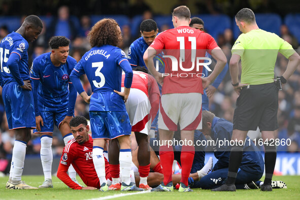 Morgan Gibbs-White of Nottingham Forest receives medical attention during the Premier League match between Chelsea and Nottingham Forest at...