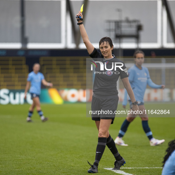 Referee Jane Simms shows a yellow card to Shannon Cooke #21 of West Ham United F.C. during the Barclays FA Women's Super League match betwee...