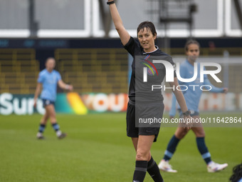 Referee Jane Simms shows a yellow card to Shannon Cooke #21 of West Ham United F.C. during the Barclays FA Women's Super League match betwee...