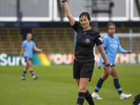 Referee Jane Simms shows a yellow card to Shannon Cooke #21 of West Ham United F.C. during the Barclays FA Women's Super League match betwee...