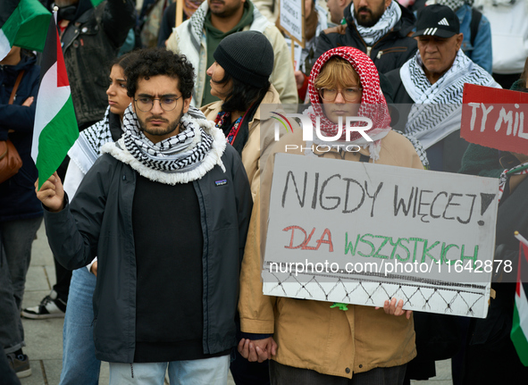 A woman holds a sign reading ''Never again! For all'' during a rally in support of Palestine and Gaza in Warsaw, Poland on 05 October, 2024....