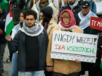 A woman holds a sign reading ''Never again! For all'' during a rally in support of Palestine and Gaza in Warsaw, Poland on 05 October, 2024....