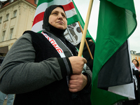 A woman holds a Palestinian flag during a rally in Warsaw, Poland on 05 October, 2024. About a hundred people marched from the Royal Castle...