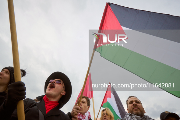 People chant during a Palestine support rally in Warsaw, Poland on 05 October, 2024. About a hundred people marched from the Royal Castle Sq...