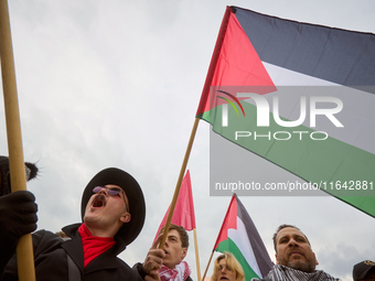 People chant during a Palestine support rally in Warsaw, Poland on 05 October, 2024. About a hundred people marched from the Royal Castle Sq...