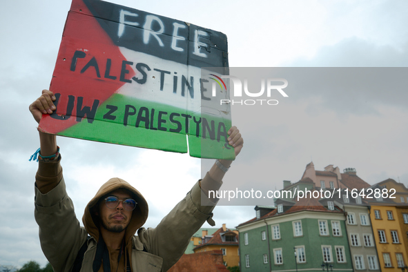 A man holds a sign during a Palestine support rally in Warsaw, Poland on 05 October, 2024. About a hundred people marched from the Royal Cas...